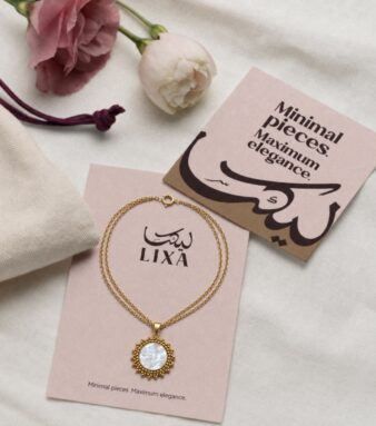 A classic round necklace design accented with a luminous white pearl.