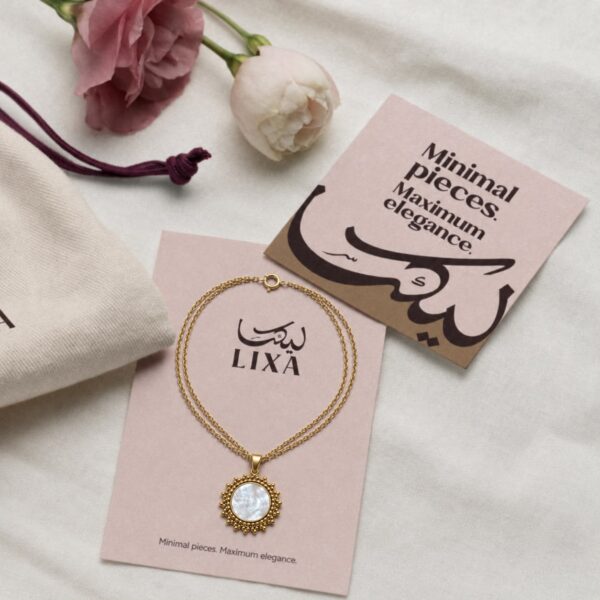 A classic round necklace design accented with a luminous white pearl.
